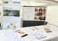 Stand in einem Pavillon mit vielen Flyern und Plakaten